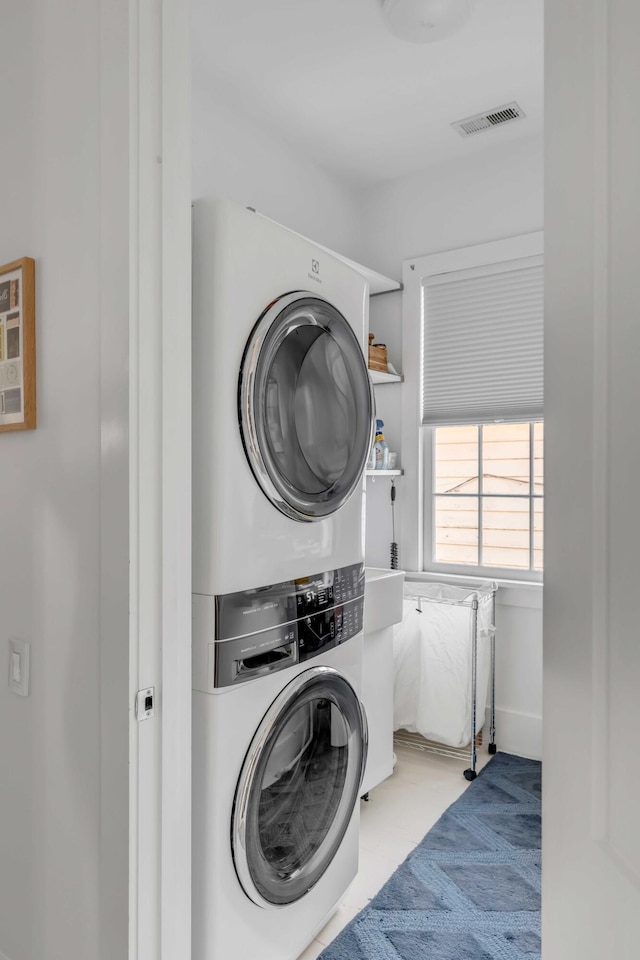 laundry area featuring stacked washer and dryer