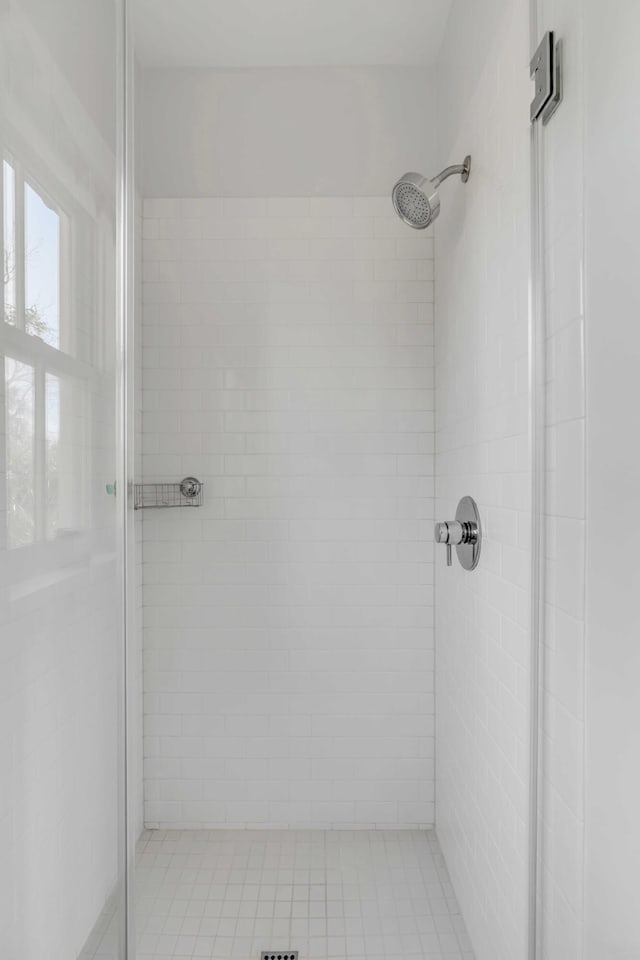 bathroom with a shower with door