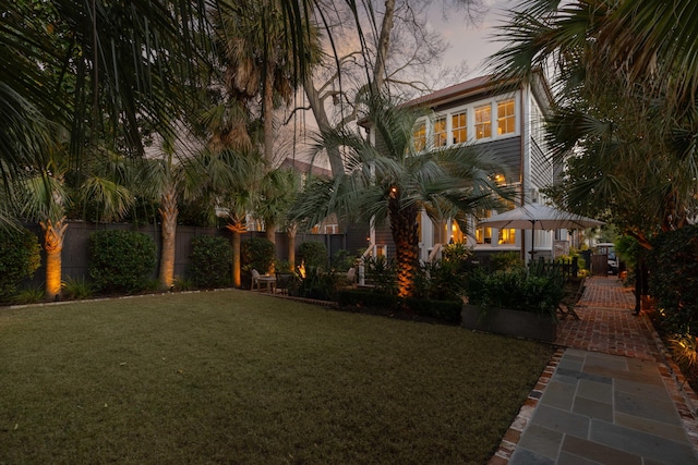 view of yard at dusk