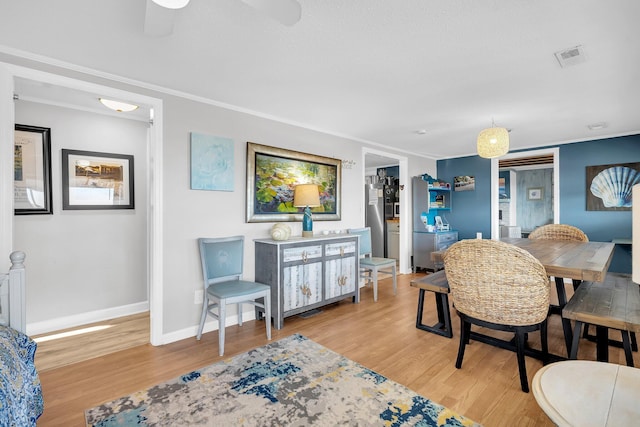 interior space featuring crown molding and light hardwood / wood-style flooring