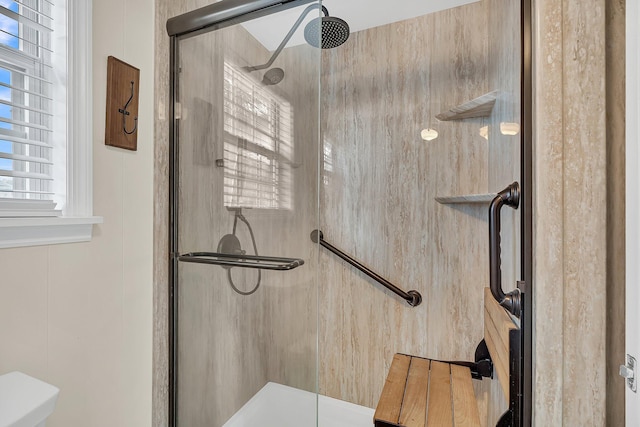 room details featuring an enclosed shower and toilet