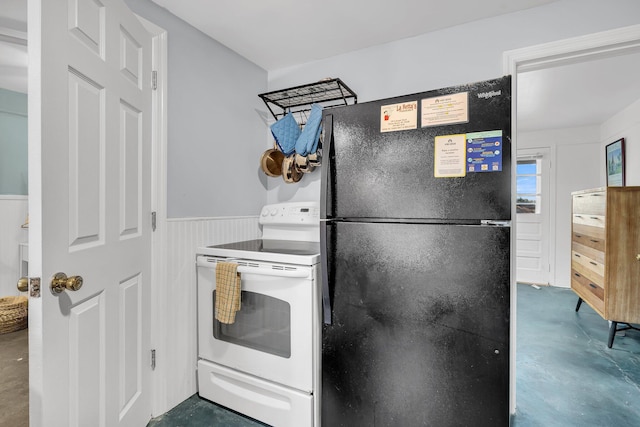 kitchen featuring black refrigerator and electric range