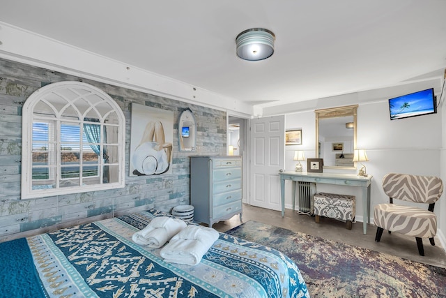 bedroom with concrete floors and wooden walls