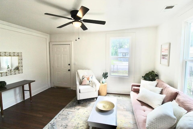 living room featuring dark hardwood / wood-style floors and ceiling fan