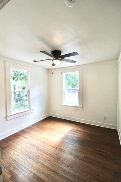 empty room featuring ceiling fan and dark hardwood / wood-style flooring