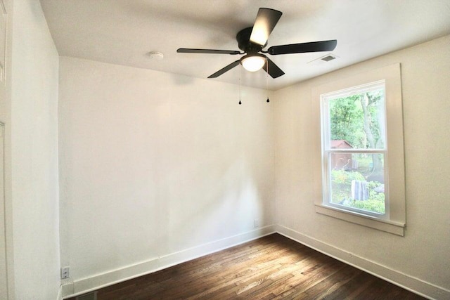 spare room featuring dark hardwood / wood-style floors and ceiling fan