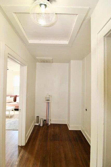 laundry room with dark wood-type flooring