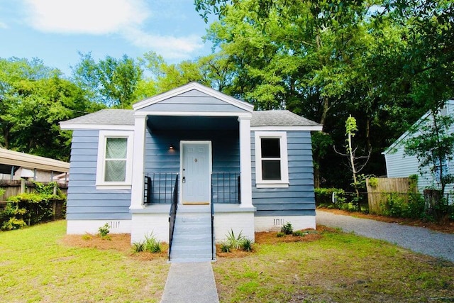 bungalow-style home featuring a front yard