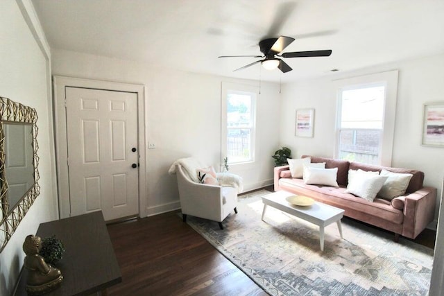 living room featuring ceiling fan and dark wood-type flooring