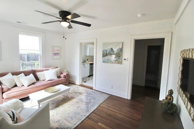 living room with dark hardwood / wood-style flooring and ceiling fan