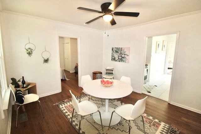 dining space with dark hardwood / wood-style floors, ceiling fan, and ornamental molding