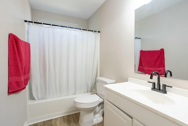 full bathroom with vanity, hardwood / wood-style flooring, shower / bath combo, and toilet