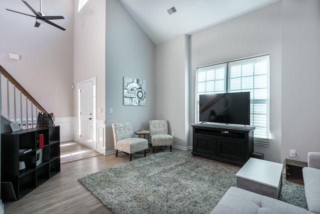 living room with hardwood / wood-style floors, a wealth of natural light, high vaulted ceiling, and ceiling fan