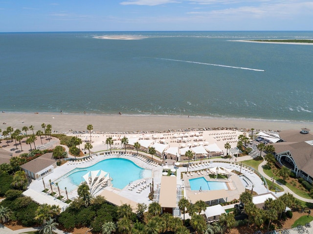 birds eye view of property with a water view and a beach view