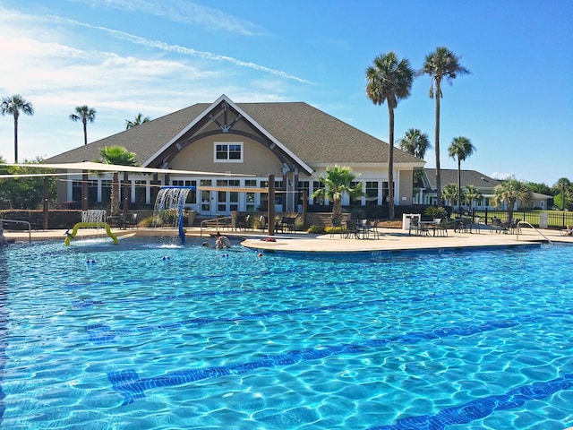 view of swimming pool featuring a patio and fence