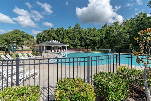 pool featuring fence, a patio, and playground community