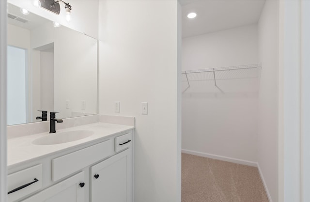 351 Blue Oak Dr, Moncks Corner, SC 29461 - bathroom featuring vanity, baseboards, recessed lighting, and a spacious closet
