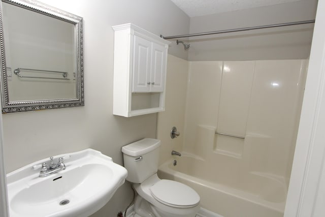 full bathroom featuring sink, shower / tub combination, a textured ceiling, and toilet