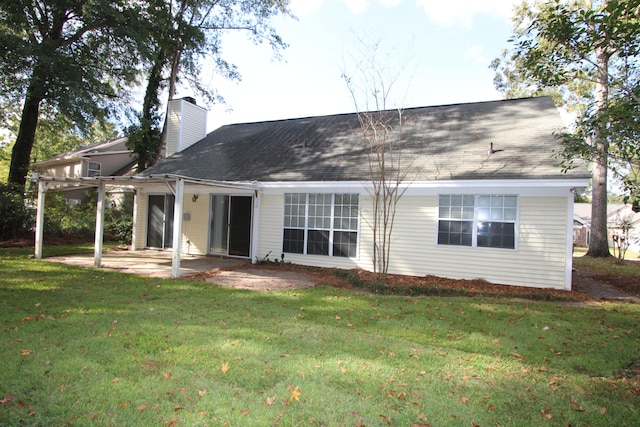 back of house featuring a patio and a lawn