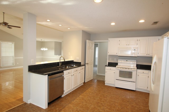 kitchen with white appliances, sink, ceiling fan with notable chandelier, and white cabinets