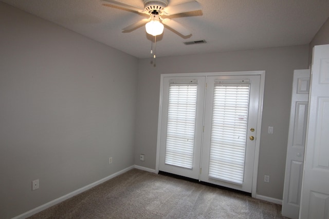 unfurnished room featuring ceiling fan, carpet, and a textured ceiling