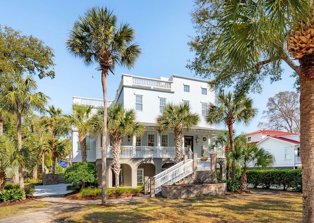 3 Cross Ln, Isle Of Palms, SC 29451 - view of front of house featuring a porch, stucco siding, stairs, and a balcony