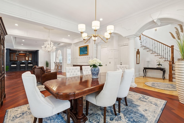 3 Cross Ln, Isle Of Palms, SC 29451 - dining room featuring a chandelier, wood finished floors, ornamental molding, decorative columns, and stairs