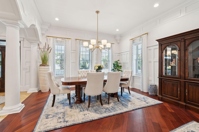 3 Cross Ln, Isle Of Palms, SC 29451 - dining room featuring a decorative wall, ornate columns, a chandelier, crown molding, and dark wood-style floors