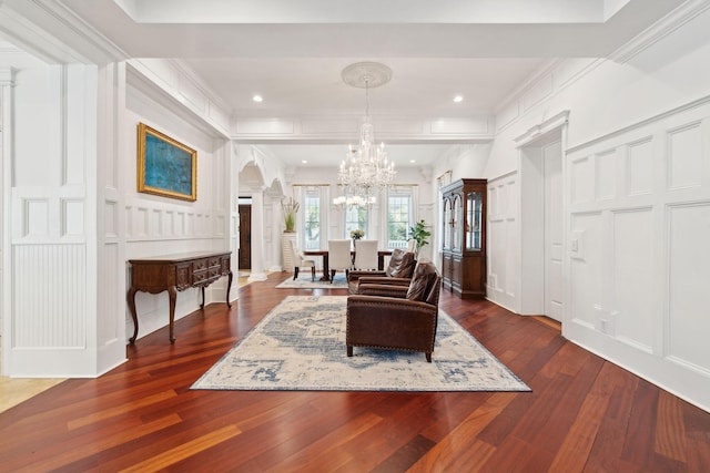 3 Cross Ln, Isle Of Palms, SC 29451 - living room with a decorative wall, a chandelier, crown molding, dark wood-type flooring, and arched walkways
