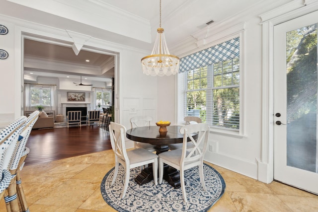 3 Cross Ln, Isle Of Palms, SC 29451 - dining area with ornamental molding, a chandelier, and a fireplace