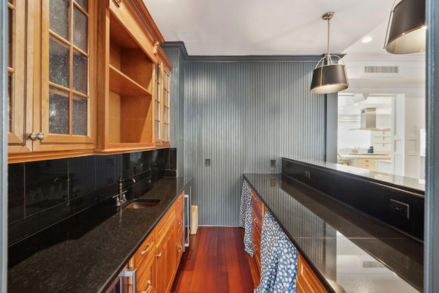 3 Cross Ln, Isle Of Palms, SC 29451 - bar area featuring a sink, dark wood-style floors, decorative light fixtures, wall chimney range hood, and crown molding