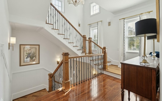 3 Cross Ln, Isle Of Palms, SC 29451 - staircase with wood finished floors, a chandelier, and wainscoting