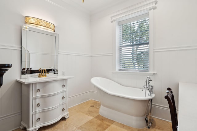 3 Cross Ln, Isle Of Palms, SC 29451 - bathroom featuring a decorative wall, a freestanding tub, vanity, wainscoting, and crown molding