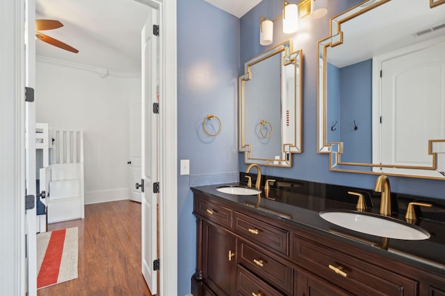 3 Cross Ln, Isle Of Palms, SC 29451 - bathroom with double vanity, a ceiling fan, and wood finished floors