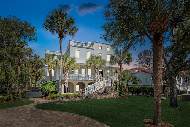 3 Cross Ln, Isle Of Palms, SC 29451 - view of front of property with stairway, a balcony, a front yard, and stucco siding