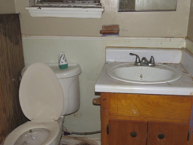 bathroom featuring toilet and vanity