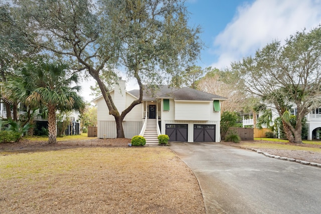 view of front of property with a garage and a front lawn