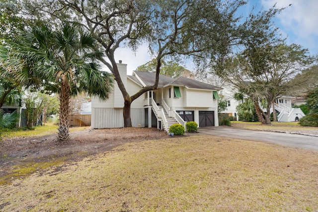 view of front of house with a garage and a front yard