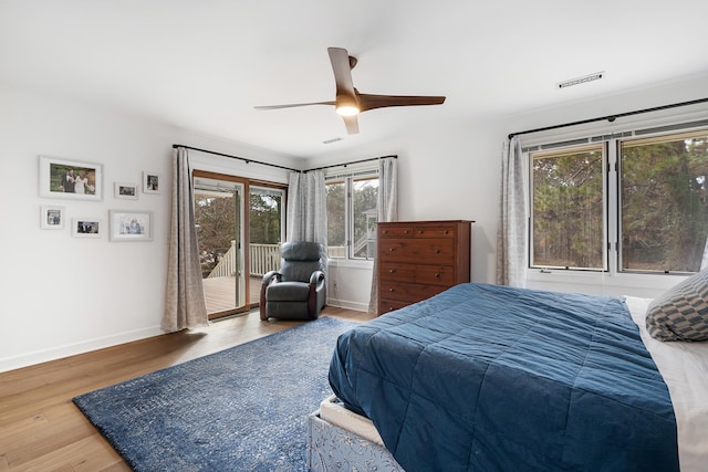 bedroom featuring access to exterior, hardwood / wood-style floors, and ceiling fan