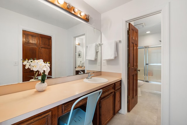 full bathroom featuring enclosed tub / shower combo, vanity, and toilet