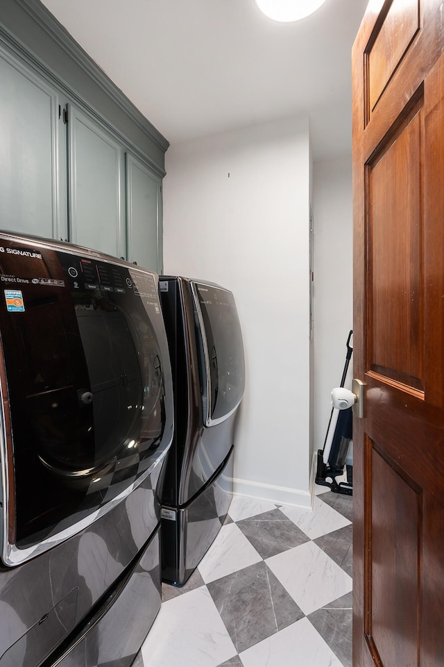 laundry room with cabinets and washer and clothes dryer