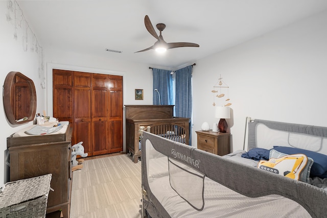 bedroom with ceiling fan and a closet