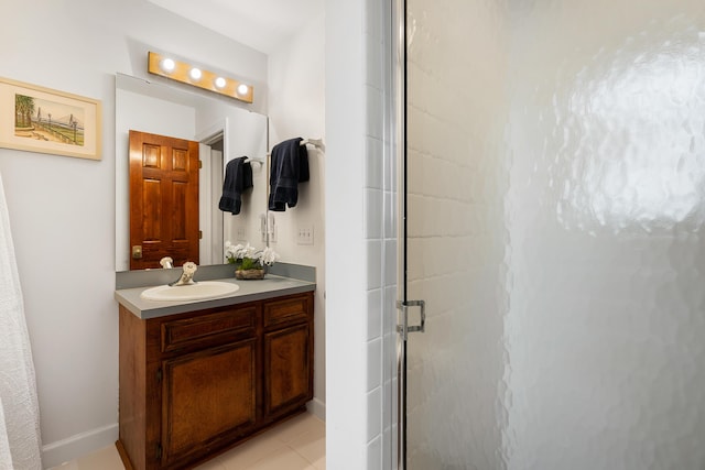 bathroom featuring tile patterned floors, vanity, and an enclosed shower