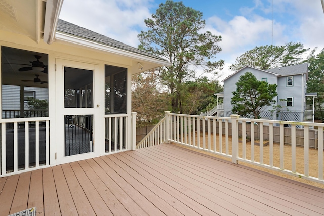 wooden deck with a sunroom and ceiling fan