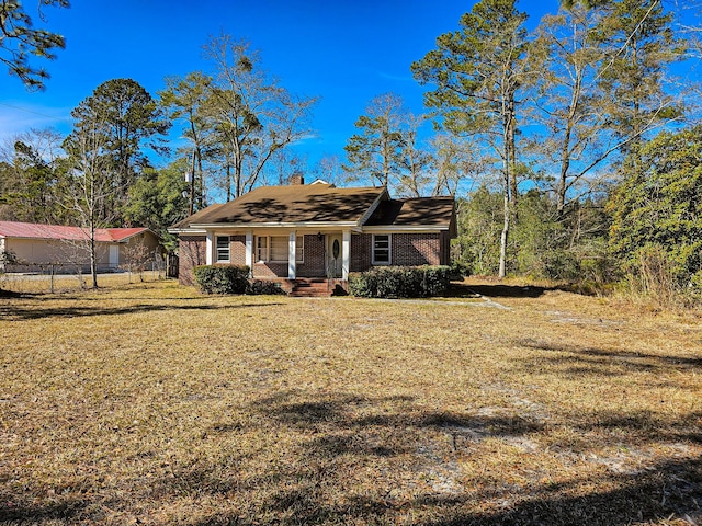 ranch-style home with a porch and a front lawn