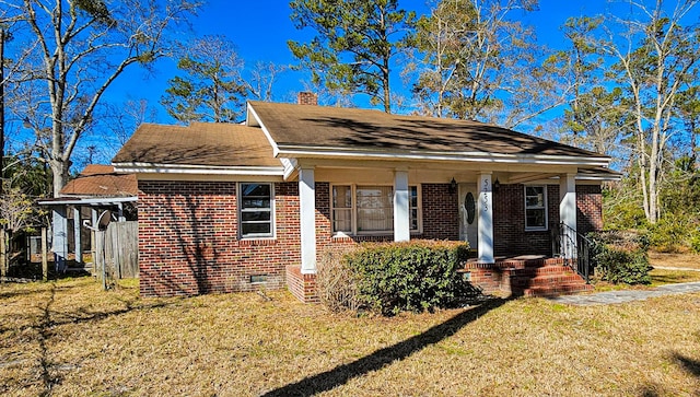 bungalow-style home featuring a front lawn