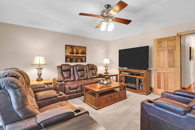 carpeted living room with a textured ceiling and ceiling fan