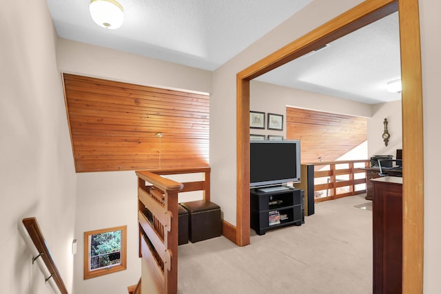 carpeted office with a healthy amount of sunlight and wooden ceiling