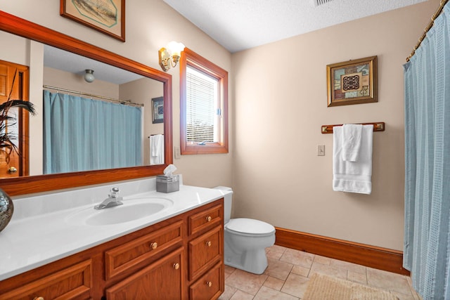 bathroom featuring toilet, vanity, tile patterned flooring, and a textured ceiling