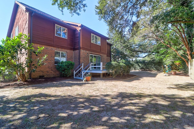 back of property with a wooden deck